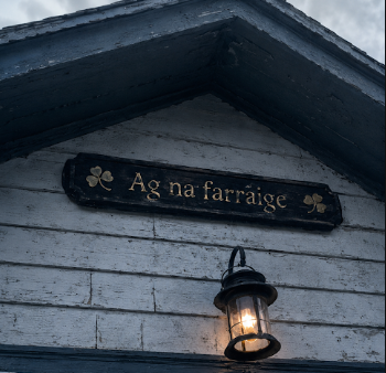 Weathered Ag na Farraige cottage sign beneath the front gable.